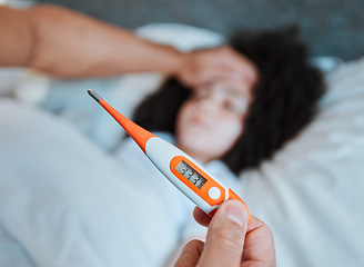 Image showing Thermometer, temperature and parent with a sick child, fever and health check in a home bedroom. Medical, care and hand of a man with a tool for covid results, virus and a cold of a girl in a bed