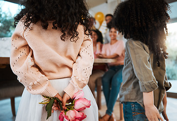 Image showing Flowers, back surprise and family at a birthday celebration with children and hiding a gift together. Love, mothers day or kids giving a floral present at a home party for parents or grandparents