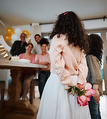 Image showing Hiding flowers, surprise and family at a birthday celebration with children with a gift together. Love, mothers day or kids giving a floral present at a home party for parents or grandparents