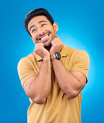 Image showing Happy, smile and man in studio with a dreaming or sweet memory or future facial expression. Happiness, excited and male model from India with positive mindset for planning isolated by blue background