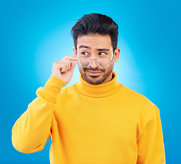 Image showing Thinking, glasses and Asian man with ideas, decision and emoji against a blue studio background. Male person, model and guy with eyewear, opportunity or choice with solution, focus or problem solving