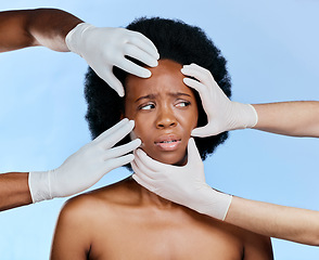 Image showing Confused, hands and black woman with check on a blue background for surgery or dermatology problem. Frustrated, African girl and doctors and inspection of skin for botox isolated on a studio backdrop