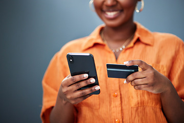 Image showing African woman, credit card and phone in studio with e commerce, digital payment or smile by background. Girl, smartphone and fintech with online shopping, bills and cybersecurity with typing password