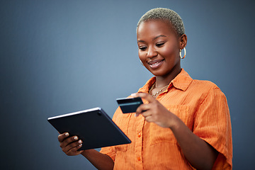 Image showing African woman, credit card and tablet in studio for e commerce, digital payment or smile by background. Girl, touchscreen and fintech with online shopping, bills or cybersecurity with typing password