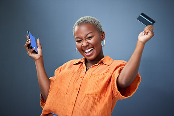 Image showing Winner, phone and credit card with a black woman online shopping in studio on a gray background. Mobile, ecommerce and wow with a happy young female shopper in celebration of deal or sale success