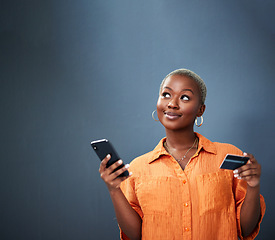 Image showing Thinking, ecommerce and credit card with a black woman using her phone in studio on a gray background. Mobile, online shopping and finance payment with a female shopper searching for a deal or sale