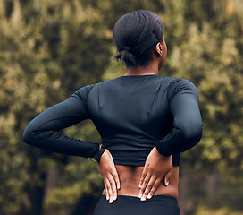 Image showing Back pain, fitness and sports woman outdoor for scoliosis, health risk and tired from running in park. Female athlete, runner and exercise injury of muscle, joint problem and first aid for hurt spine