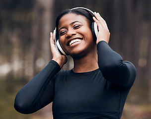 Image showing Fitness, black woman listening to music and in woods with headphones happy for workout. Exercise or workout, training or happy and female athlete listen to radio or podcast for motivation in nature