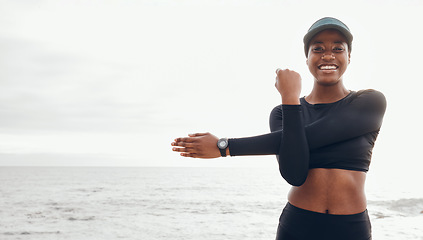 Image showing Portrait of woman stretching by ocean for fitness in nature for exercise, marathon training and running. Sports, mockup and African female person stretch arms for warm up, cardio workout and wellness