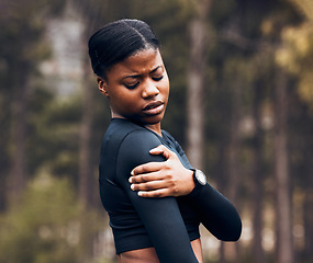 Image showing Shoulder, pain and sports woman outdoor for health risk, bruise and hands on wound in park. Fitness, black female athlete and arm injury of muscle, joint problem and first aid for exercise accident