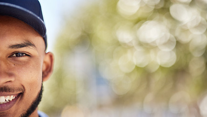 Image showing Portrait, mockup and blurred background with a man in nature, outdoor during summer for adventure. Half face, smile and green space with a happy young male person wearing a cap during the day