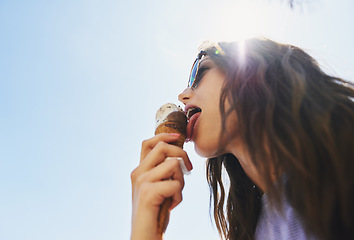 Image showing Summer, below and a woman with ice cream on a blue sky for freedom, travel and sweet food. Sun, holiday and a young girl with a dessert during a vacation in spring or a eating gelato and thinking