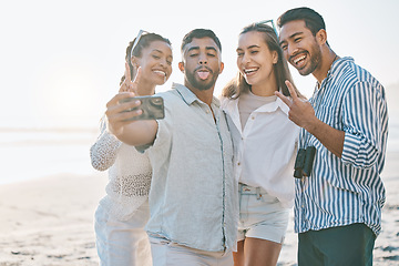 Image showing Happy friends, selfie and beach for memory, photo or picture in goofy or silly fun together in nature. Group of people with smile and peace sign on ocean coast for vlog, online post or social media