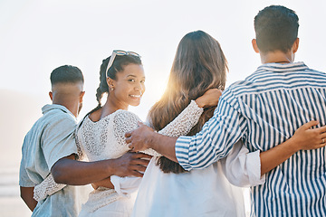 Image showing Happy friends, back and hug on beach for sunset holiday, vacation or weekend together in nature. Rear view group of people standing for quality bonding time, trip or travel by the ocean coast outside