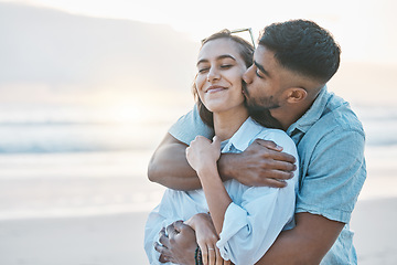 Image showing Couple, hug and kiss on beach with love, travel and holiday with mockup space and happy together outdoor. Summer, support and care with affection, man and woman in nature with adventure by the ocean