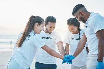 Image showing Volunteering, team huddle and cleaning beach for world earth day, care for nature and environment. Help, recycle and support in teamwork, group of people at ocean to clean plastic waste and pollution