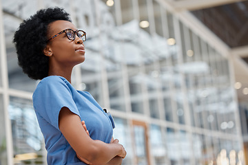 Image showing Nurse, arms crossed and thinking with black woman in hospital for medical, idea and expert. Medicine, healthcare and nursing with female person in clinic for wellness, mockup space and surgery