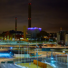 Image showing Modern grain terminal at night. Metal tanks of elevator. Grain-drying complex construction. Commercial grain or seed silos at seaport. Steel storage for agricultural harvest