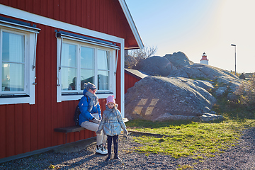 Image showing Attractive young woman with her little cute daughter are spending time together outdoors