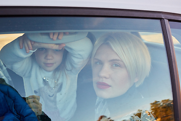 Image showing Family concept. Portrait of mother and daughter through the glass of a car