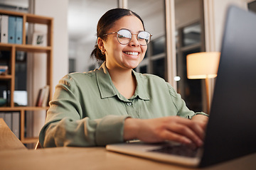 Image showing Laptop, office and happy business woman online for project, writing email and working late at night. Technology, networking and female person on computer for website, planning and research at desk