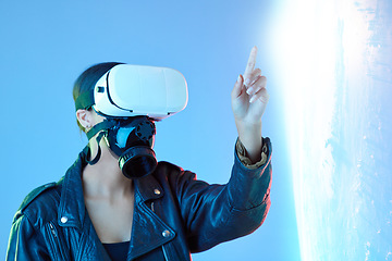 Image showing Woman, point and virtual reality glasses in studio with holographic explosion, game or tech in metaverse. Girl, futuristic ar goggles and gas mask in digital transformation, vision or user experience