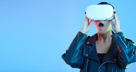 Image showing VR, glasses and woman, wow or surprise on studio, blue background for cyberpunk, gaming and streaming 3d video. High tech, virtual reality and excited gen z person with grunge fashion and mockup