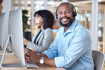 Image showing Call center, portrait of black man and smile at computer for customer service, business support and contact us in CRM office. Happy telemarketing agent at desktop for consulting in coworking agency