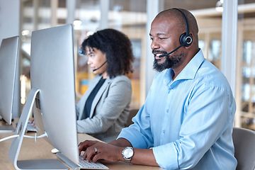 Image showing Call center, black man and consultant at computer for customer service, business support or help in CRM office. Happy telemarketing agent typing at desktop for telecom consulting in coworking agency