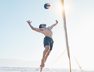 Image showing Beach, exercise and man with fitness, volleyball and fun with sunshine, moving and healthy. Male person, athlete and player with seaside sports, game with speed or workout goals with sand or wellness