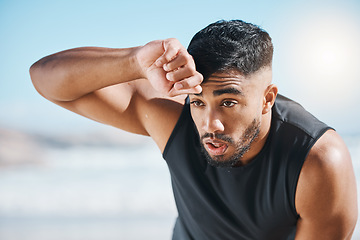 Image showing Tired, sweating and fitness break for man outdoor after training, running or cardio workout on blurred background. Sweat, face and Indian male runner with sports fatigue, dehydration from exercise