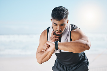 Image showing Man, fitness and checking watch for pulse, heart rate or performance on break after workout on the beach. Fit, active and sporty male person with wristwatch for monitoring body exercise by the ocean