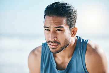 Image showing Fitness, break and man breathing at the beach after training, running and intense cardio, focus and resting. Face, breathe and Mexican male runner stop to breathe during cardio workout at the sea