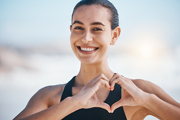 Image showing Woman, portrait and heart hands, fitness outdoor with love icon and emoji, happiness and health. Wellness, support and care with female athlete, exercise and symbol, hand gesture and feedback