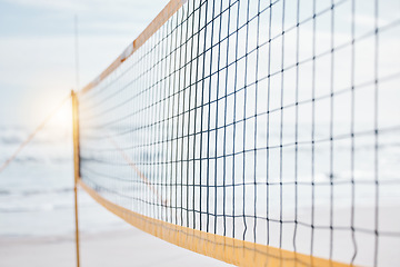 Image showing Background, volleyball and closeup of net at beach for fun competition, contest and flare in sunshine. Sports posts, barrier and rope design at sea for outdoor summer games, match or team performance