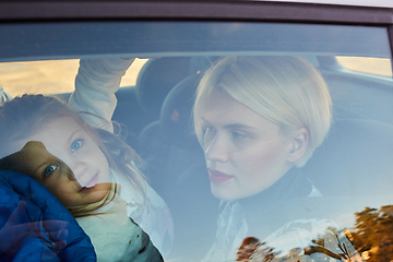 Image showing Family concept. Portrait of mother and daughter through the glass of a car