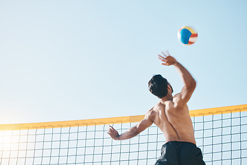 Image showing Volleyball, man and spiking, net with sports and fitness outdoor, playing game with blue sky and summer. Exercise, male athlete and match with ball and active, workout and action with tournament