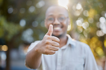 Image showing Black man, hands and thumbs up in park for success, good job or approval in the nature outdoors. Portrait of happy African male person show thumb emoji, yes sign or like for agreement or deal outside