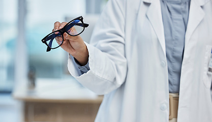 Image showing Optometry, health and closeup of a optometrist with glasses at optical store or clinic. Eye care, wellness and zoom of optician or medical worker with prescription spectacles or eyewear frame at shop