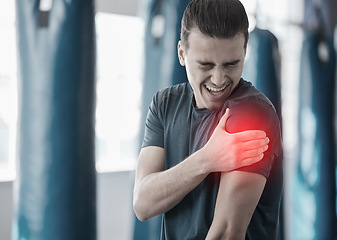 Image showing Hand, shoulder pain and the arm of a man in red highlight during a fitness workout. Healthcare, medical and emergency with a male athlete holding his joint after an accident or injury in the gym