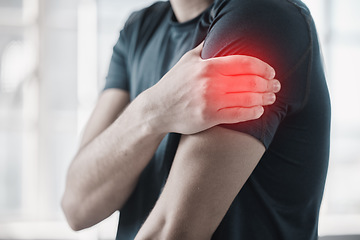 Image showing Hand, shoulder pain and injury with the arm of a man in red highlight during a fitness workout. Healthcare, medical and emergency with a male athlete holding a joint after an accident in the gym