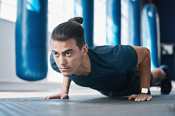 Image showing Fitness, push up or man in gym training or exercising in a workout for endurance or strong arms. Healthy person, focus or powerful sports athlete in exercise challenge for wellness or development