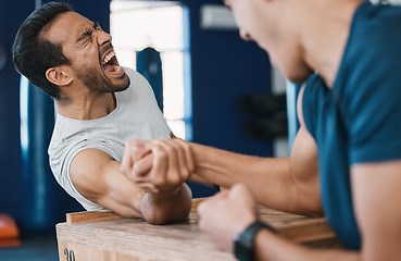 Image showing Strong, loser or men arm wrestling at gym on a table in playful challenge together in fitness training. Game, pain or strong people in muscle power battle for sports, hard competition or tough match