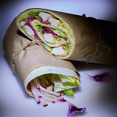 Image showing Healthy lunch snack. Stack of mexican street food fajita tortilla wraps with grilled buffalo chicken fillet and fresh vegetables