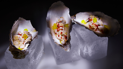 Image showing Fresh Oyster salad on the half shells.