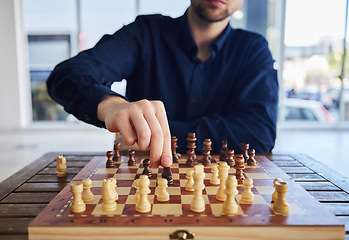 Image showing Chess, man moving a knight and game of strategy, problem solving or person playing on chessboard in competition. Planning, choice and hand on piece or king, queen and player thinking of winning move