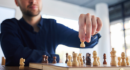 Image showing Chess, man moving a pawn and game of strategy, problem solving or person playing on chessboard in competition. Planning, choice and hand on knight or king, queen and player thinking of winning move