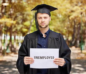 Image showing Portrait, graduation and unemployment with a student man holding a sign outdoor for debt, loans or jobless. Economy, future and depression with an unhappy college pupil during a labor crisis