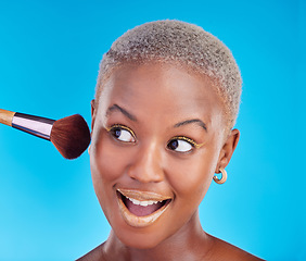 Image showing Black woman, face and brush of makeup in studio for application of foundation on blue background. Happy female model, wow and brushing beauty powder on skin with cosmetic tools for facial aesthetic