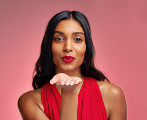 Image showing Woman, red lipstick and beauty, blow kiss with makeup and flirt, cosmetics and glow on pink background. Cosmetology, Indian female model pout with color in portrait and shine with wellness in studio